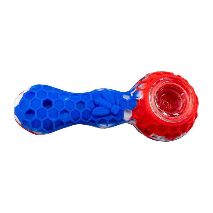 "A blue and red Silicone Bee Spoon that is embossed with a honeycomb-pattern design and adorned with a bee on the bodice," - Up N Smoke.