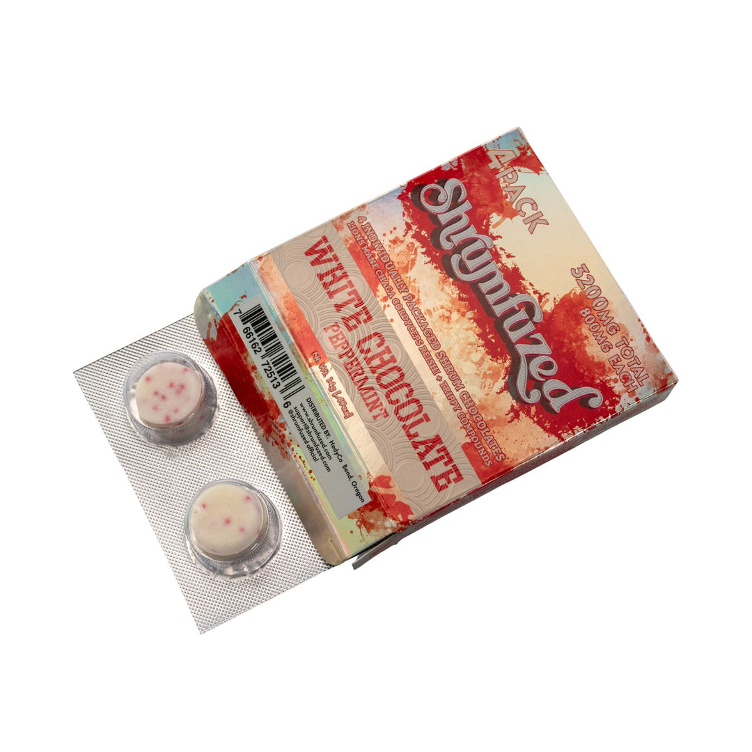 "Slightly open box of a Shrumfuzed Mushroom White Chocolate Peppermint 4pk on a white background," - Up N Smoke.