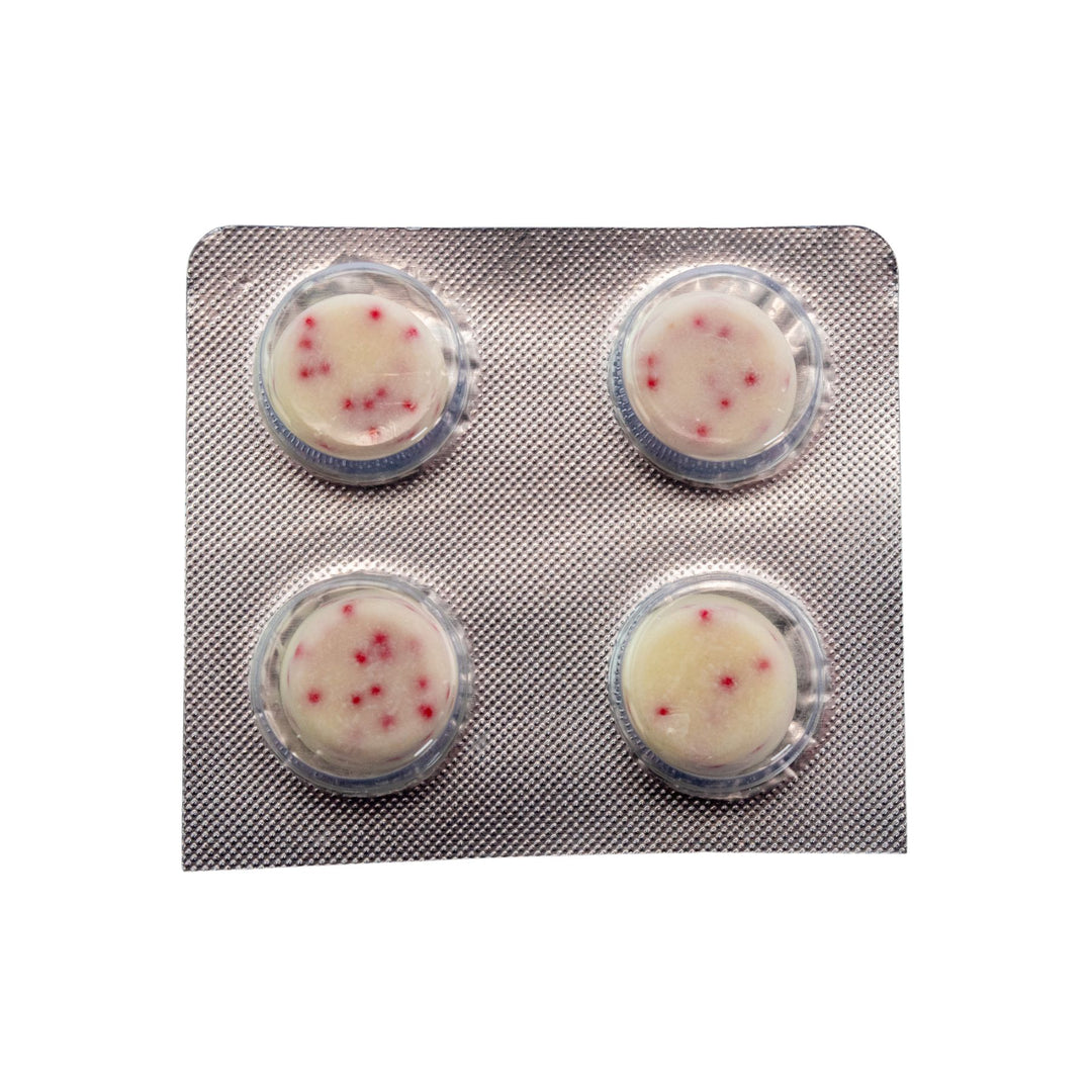 "Four round Shrumfuzed White Chocolate Peppermint morsels in a blister pack on a white background," - Up N Smoke.
