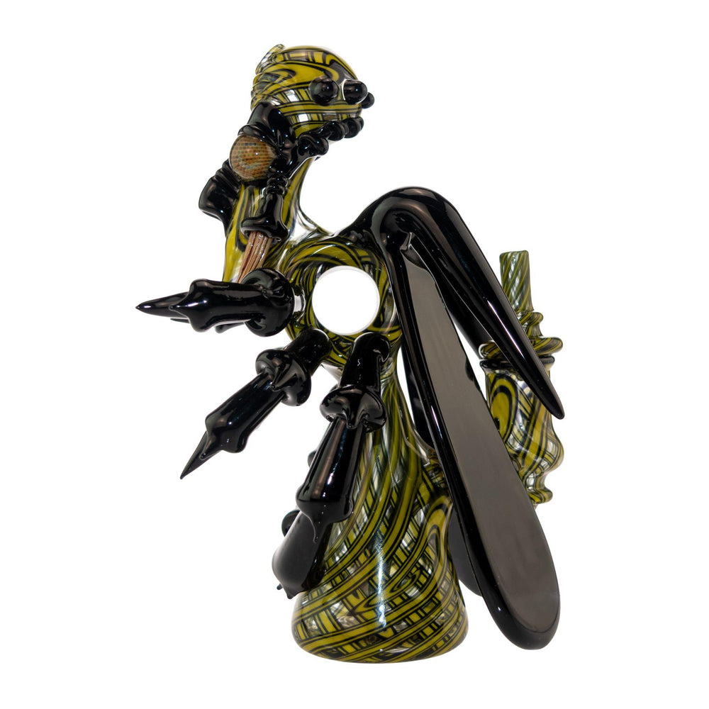 "Left side of a Shuhbuh Glass Wasp Rig that stands at 7.25 inches tall and has a base diameter of 2 inches," - Up N Smoke.