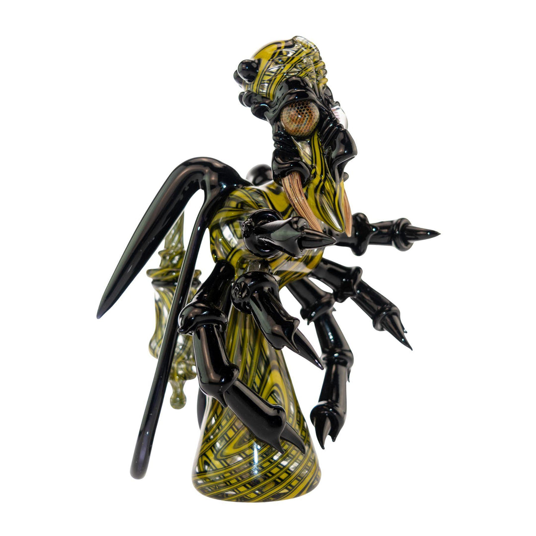 "Heady functional glass rig made by Shuhbuh GlassWorks that is shaped like a wasp on a white background," - Up N Smoke.