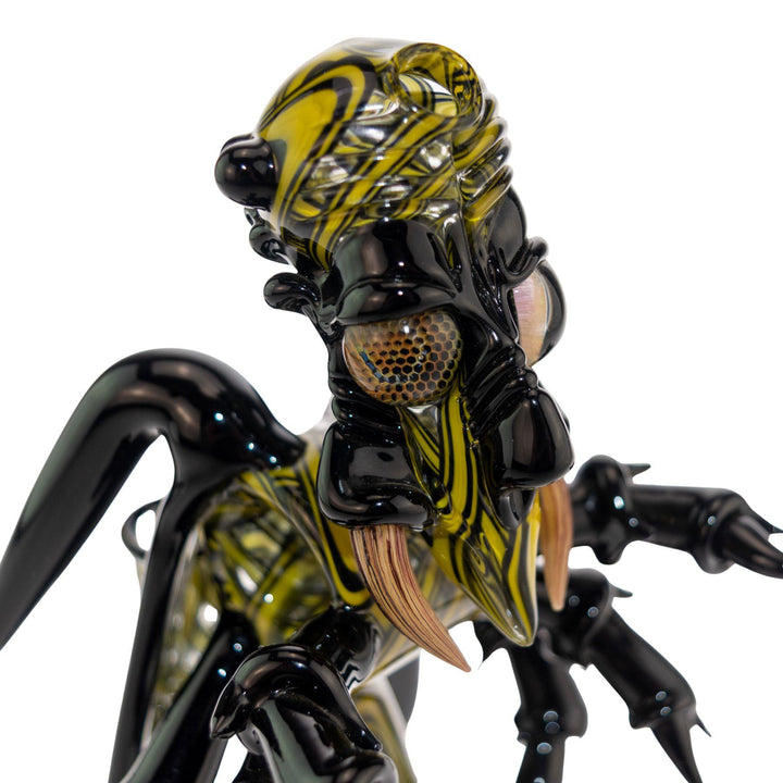 "Close-up of the head of a Shuhbuh Glass Wasp Rig, showcasing the honeycomb eyes on a white background," - Up N Smoke.
