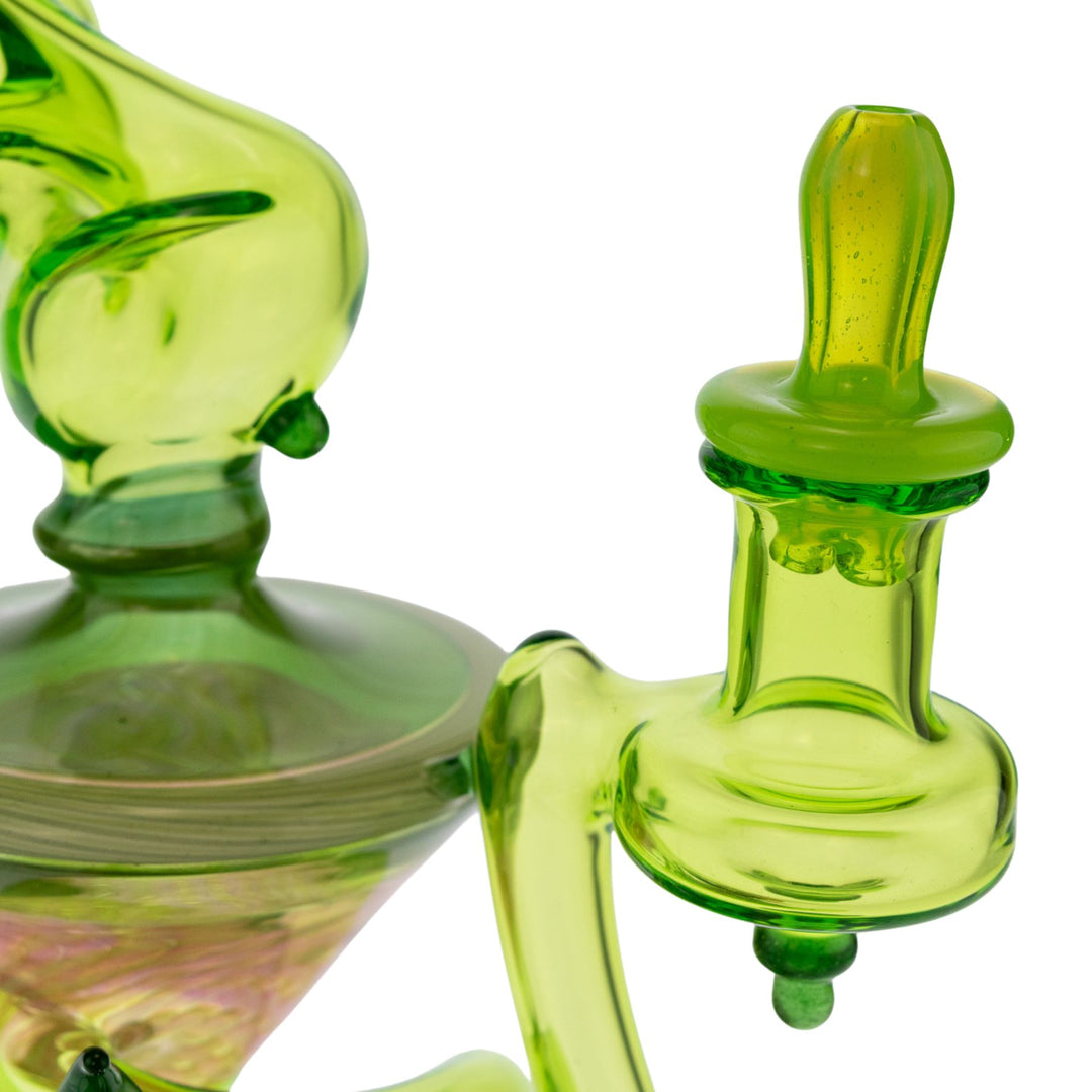 "Close-up of the carb cap and fixed downstem of a Sol Fire Glass Weed Fairy Recycler on a white background," - Up N Smoke.