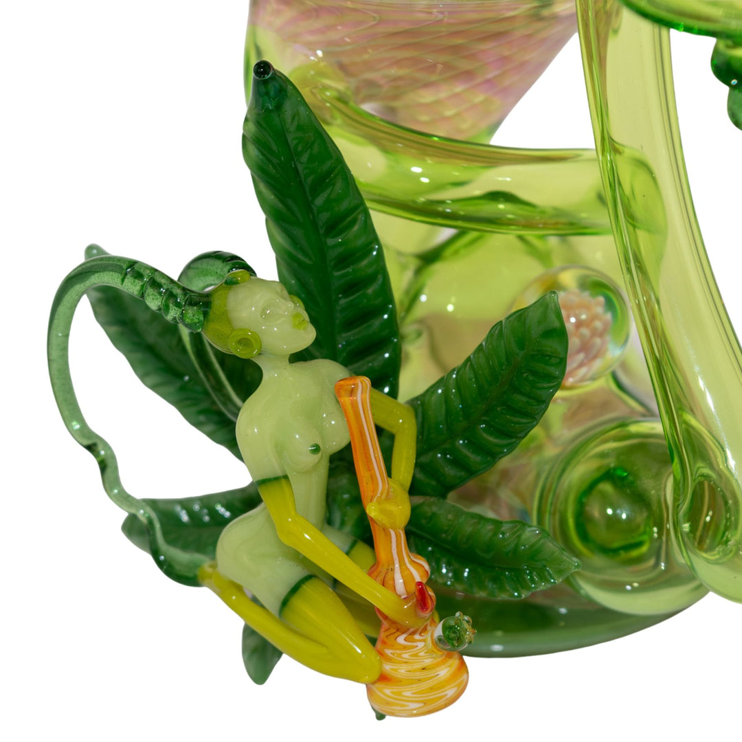 "Close-up of a weed fairy adorned to a Sol Fire Glass Recycler on a white background," - Up N Smoke.