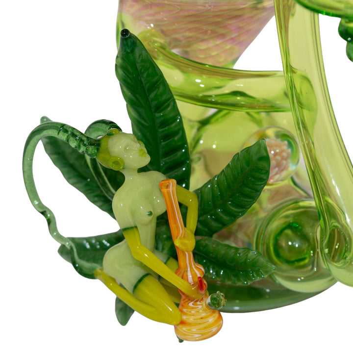 "Close-up of a weed fairy adorned to a Sol Fire Glass Recycler on a white background," - Up N Smoke.