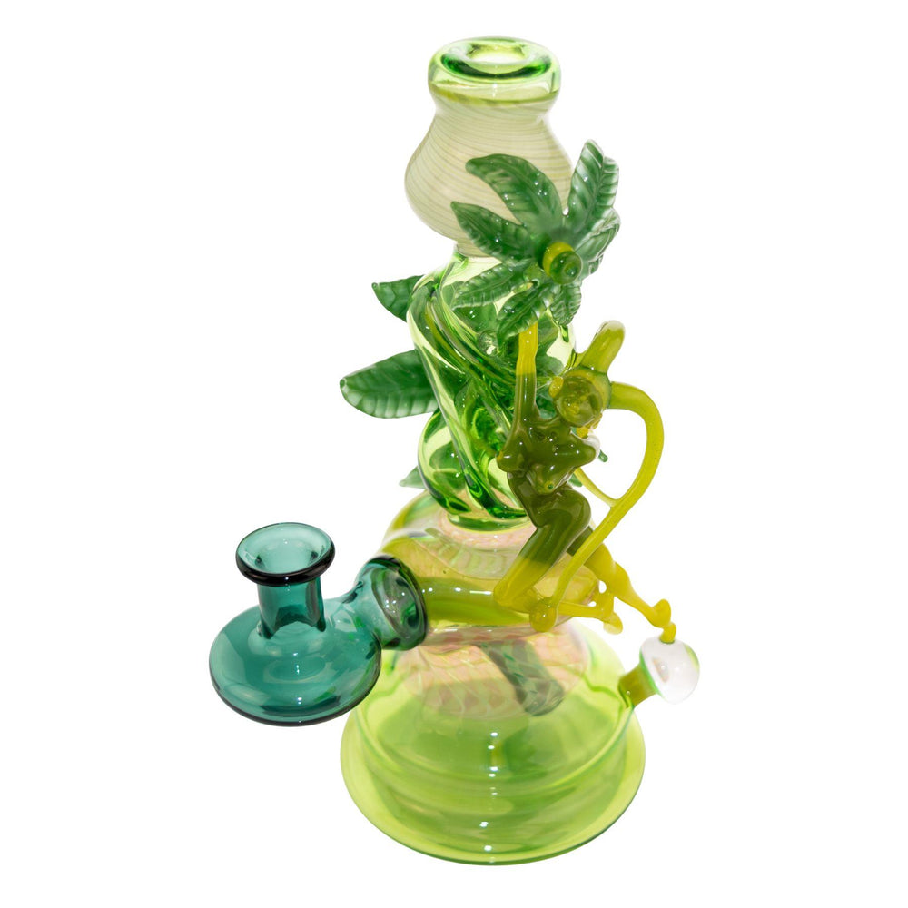 "Left side of a Sol Fire Weed Fairy Bubbler that features a fairy taking flight off of an opal bead on a white background," - Up N Smoke.