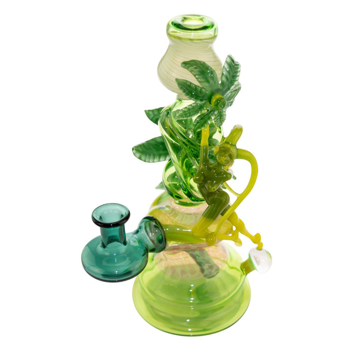 "Left side of a Sol Fire Weed Fairy Bubbler that features a fairy taking flight off of an opal bead on a white background," - Up N Smoke.