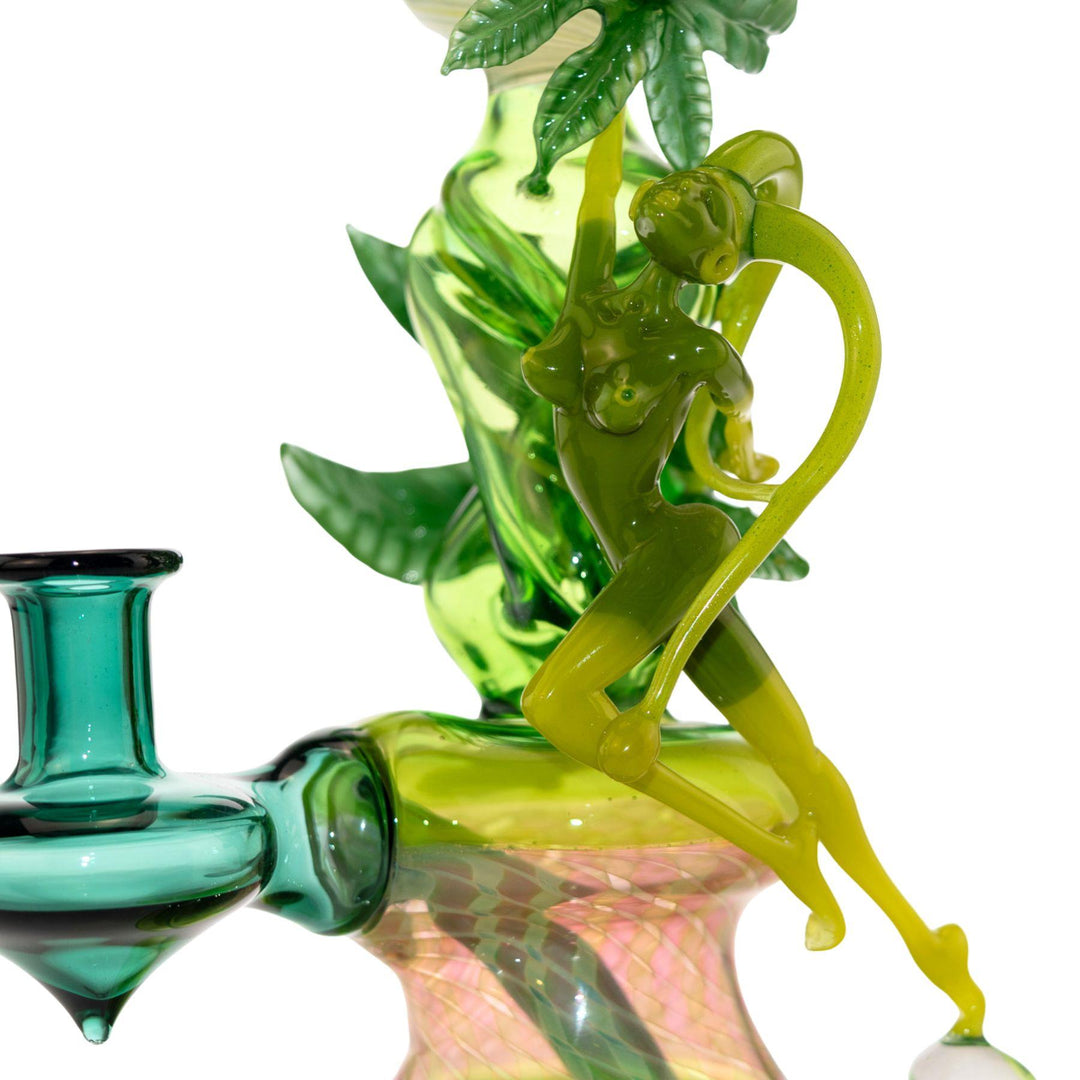 "Close-up of a glass fairy taking flight off of an opal bead of the Sol Fire Weed Fairy Bubbler on a white background," - Up N Smoke.