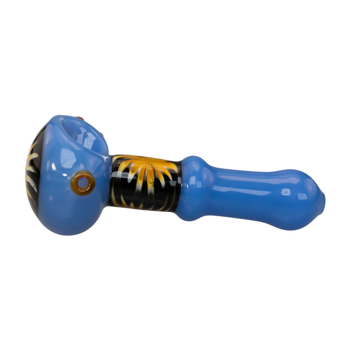 "Left-side of a blue Pulsar Step Into Now Herb Spoon that is 4.5'' and features a bright yellow sunburst design on the handle and bowl head," - Up N Smoke.