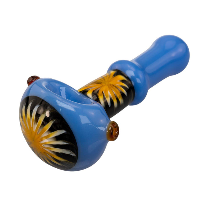 "Close-up view of the yellow sunburst design on the bowl head of a blue Pulsar Step Into Now Herb Spoon on a white background," - Up N Smoke.