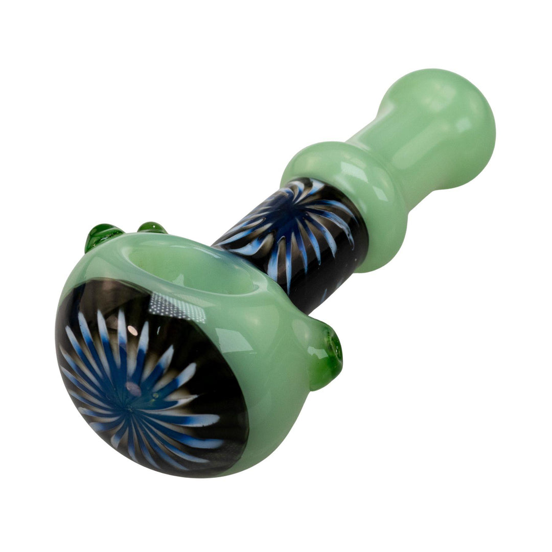 "Close-up view of the black and blue sunburst design wrapped around the neck and bowl head of a green Step Into Now Pulsar Herb Spoon," - Up N Smoke.