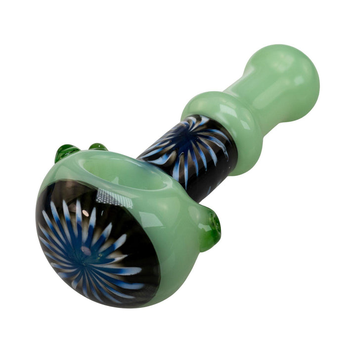 "Close-up view of the black and blue sunburst design wrapped around the neck and bowl head of a green Step Into Now Pulsar Herb Spoon," - Up N Smoke.