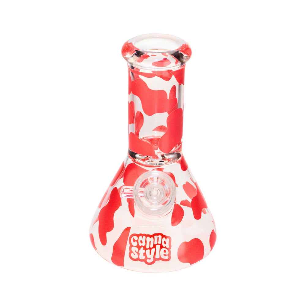 "A small 6.5-inch water pipe made from borosilicate glass, featuring a pink cow print design with a straight tube and a stable wide base, perfect for portability and compact use." - Up N Smoke.