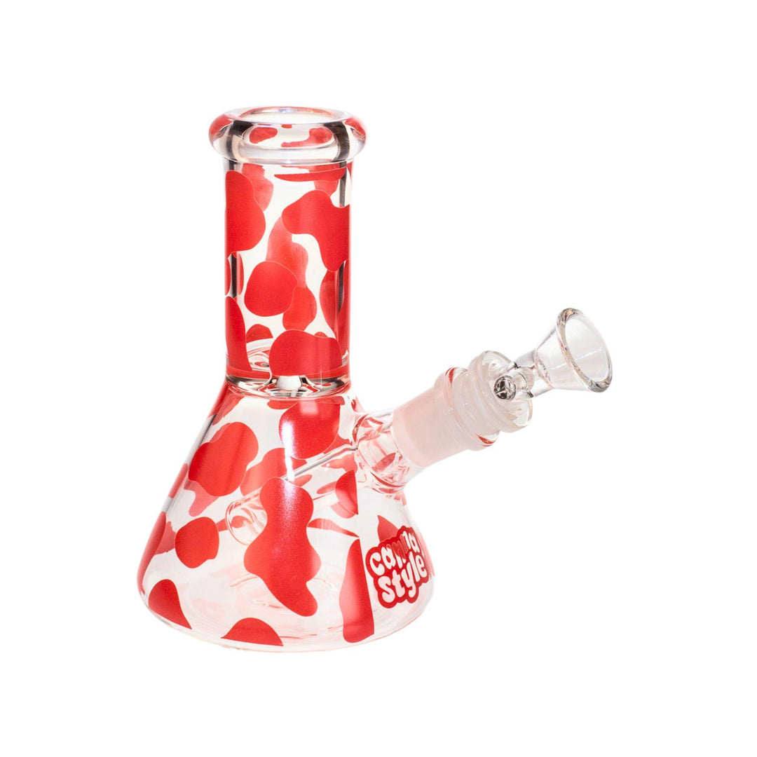 "A compact 6.5-inch water pipe crafted from borosilicate glass, showcasing a playful pink cow print design. Its straight tube and wide, stable base make it ideal for portability and convenient use." - Up N Smoke.