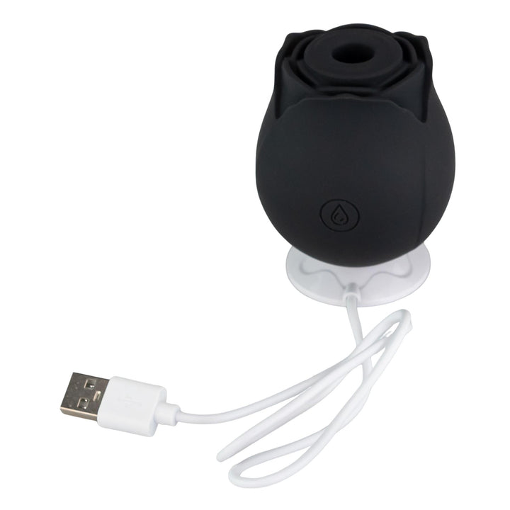 Suction Rose Toy black color high angle displayed on charging mount on a white background - Up N Smoke