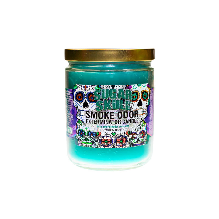  "Close-up of the Sugar Skull Smoke Odor Exterminator Candle. The jar features a vibrant, colorful label with a detailed sugar skull design. The candle inside has a bright turquoise wax, and the label highlights its enticing fragrance blend, perfect for eliminating smoke and other odors." - Up N Smoke.