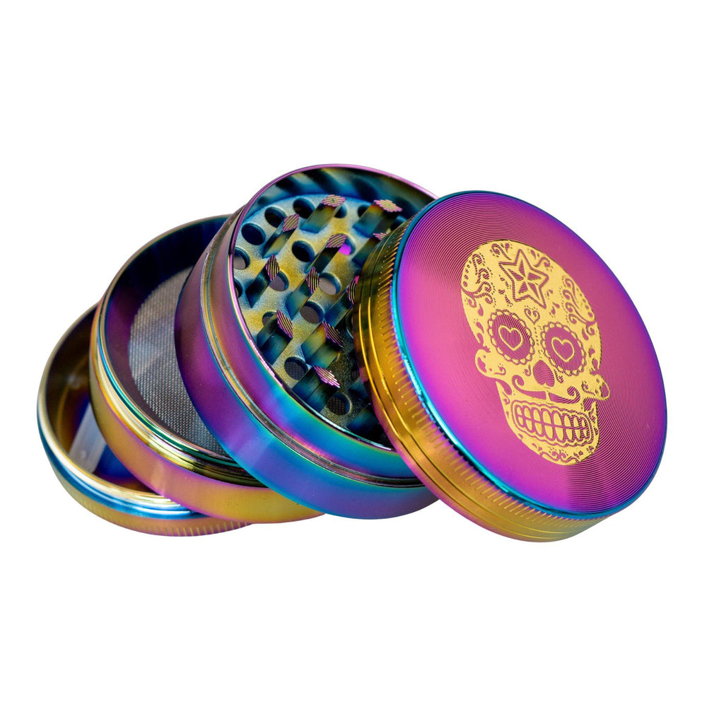 "4-Piece Sugar Skull Grinder with its compartments splayed out and stacked upon one another on a white background," - Up N Smoke.