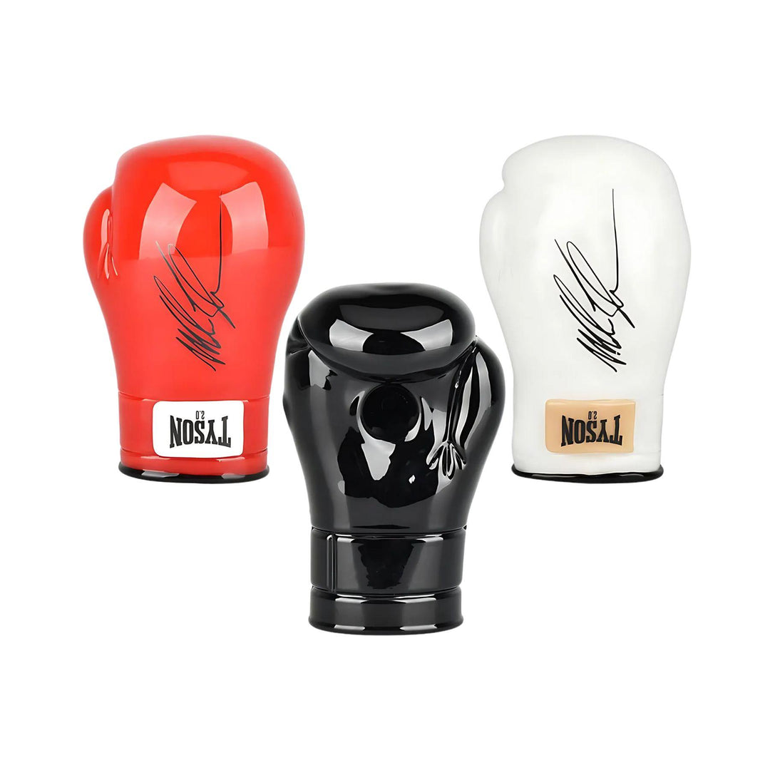 "Group photo of three Mike Tyson Glove hand pipes in different colors, featuring a bowl in the palm of the glove and Mike Tyson's signature on the exterior." - Up N Smoke.