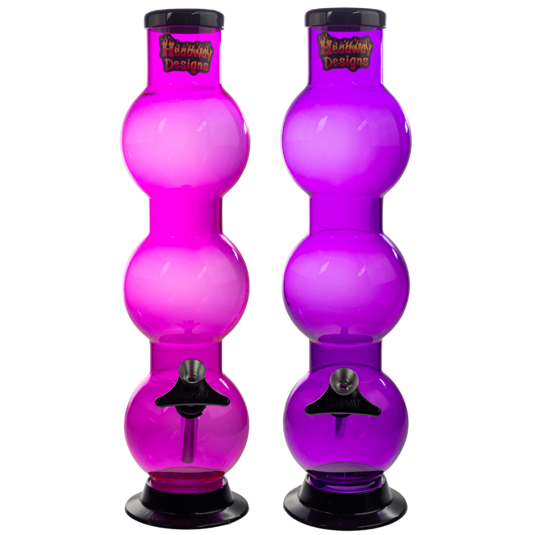 Photograph of the front of two triple bubble Headway Designs water pipes. The one on the left is a magenta, and the right piece is a deep purple. - Up N Smoke.