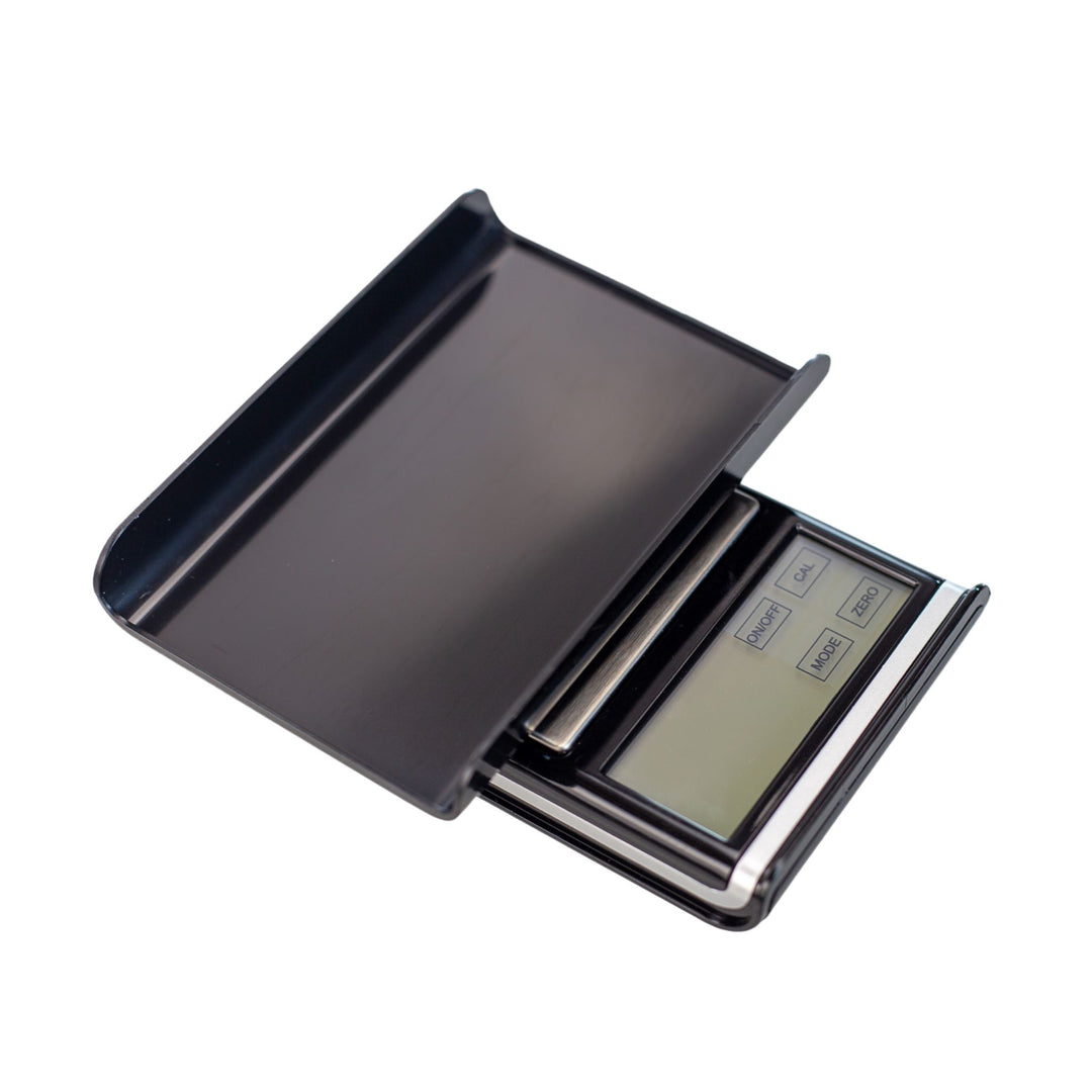 Top down view of a scale with its lid flipped upside down to be utilized as a tray. This product features the largest pocket-sized scale touch screen and can read six different forms of weight. - Up N Smoke.