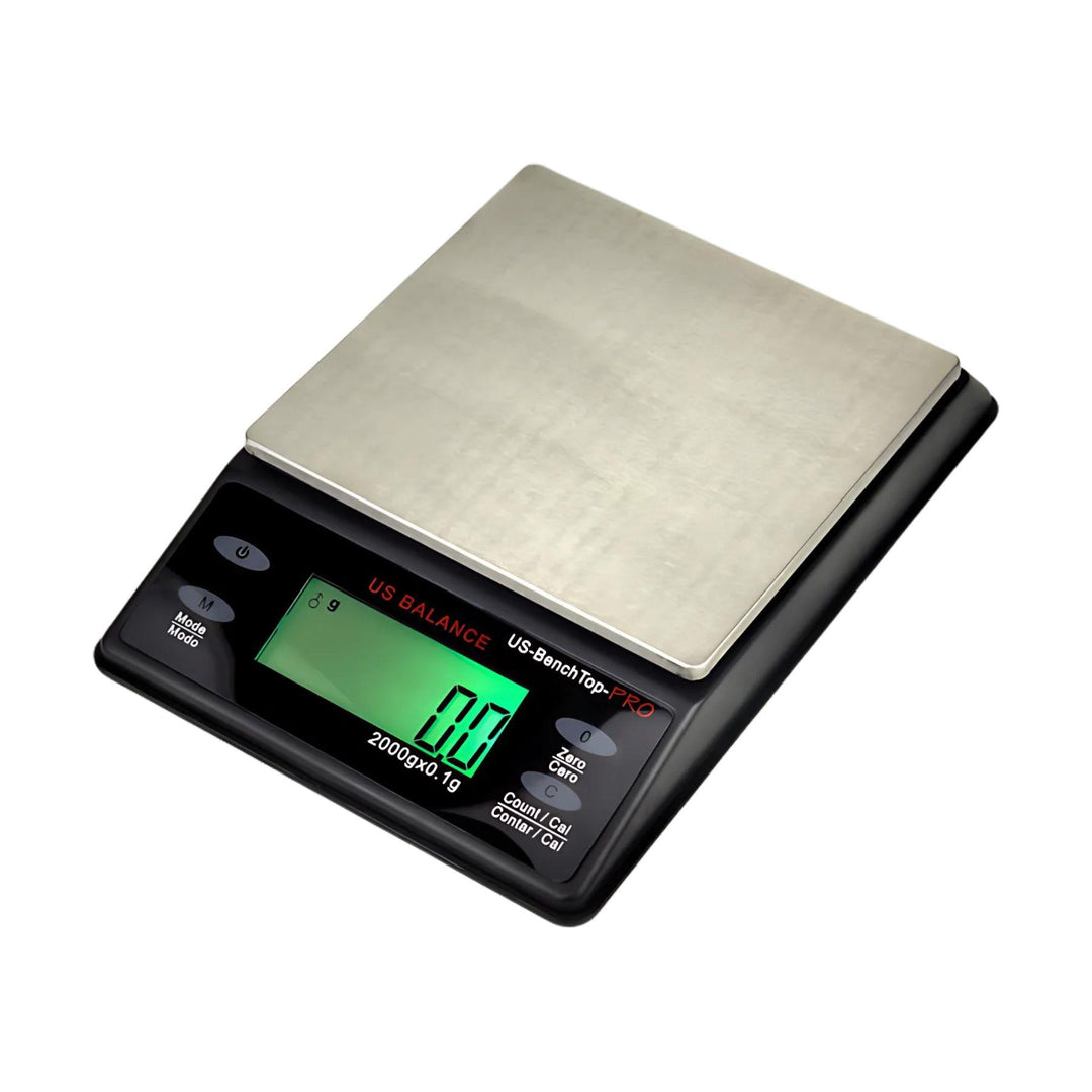 "Close-up of the US-BENCHTOP-PRO Digital Scale showing its black design, compact size, and easy-to-read LCD screen." - Up N Smoke.