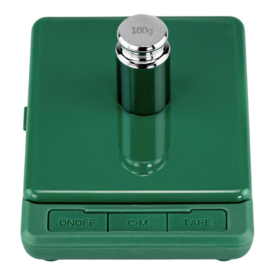 "Green electronic scale with a 100g weight on a white background," - Up N Smoke.