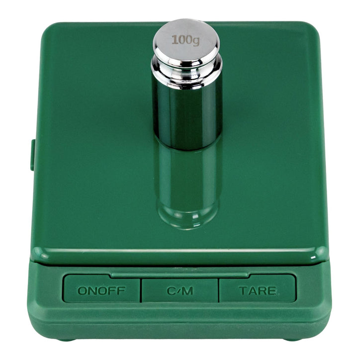 "Green electronic scale with a 100g weight on a white background," - Up N Smoke.