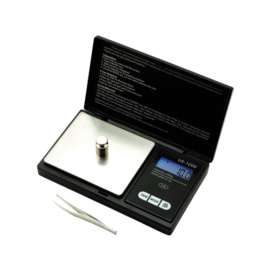 "A pocket-sized scale, model US-1000 from US Balance, is open to show a calibration weight on the stainless steel platform." - Up N Smoke.