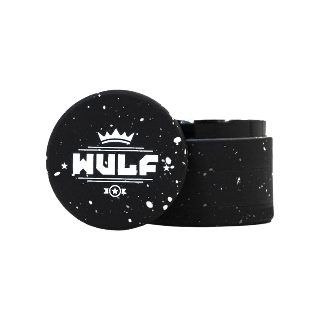 "50mm WULF 4-Piece Grinder that is black with a white splatter design," - Up N Smoke.