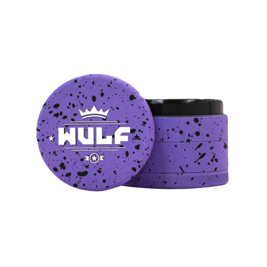 "WULF 4-Piece Grinder in the variation purple with black splatter on a white background," - Up N Smoke.