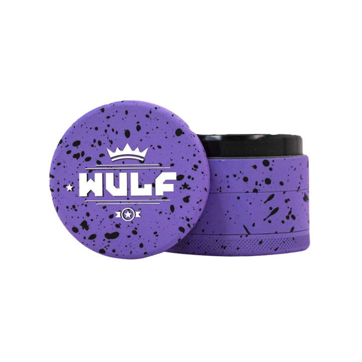 "WULF 4-Piece Grinder in the variation purple with black splatter on a white background," - Up N Smoke.