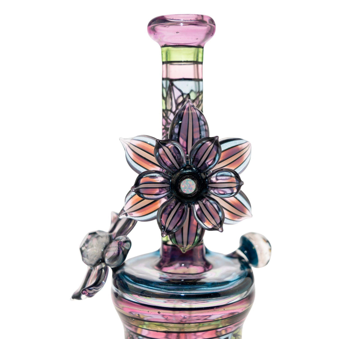 "Close-up of a Windstar x Mars Heady Collab, showcasing the rotating opal flower on a white background," - Up N Smoke.