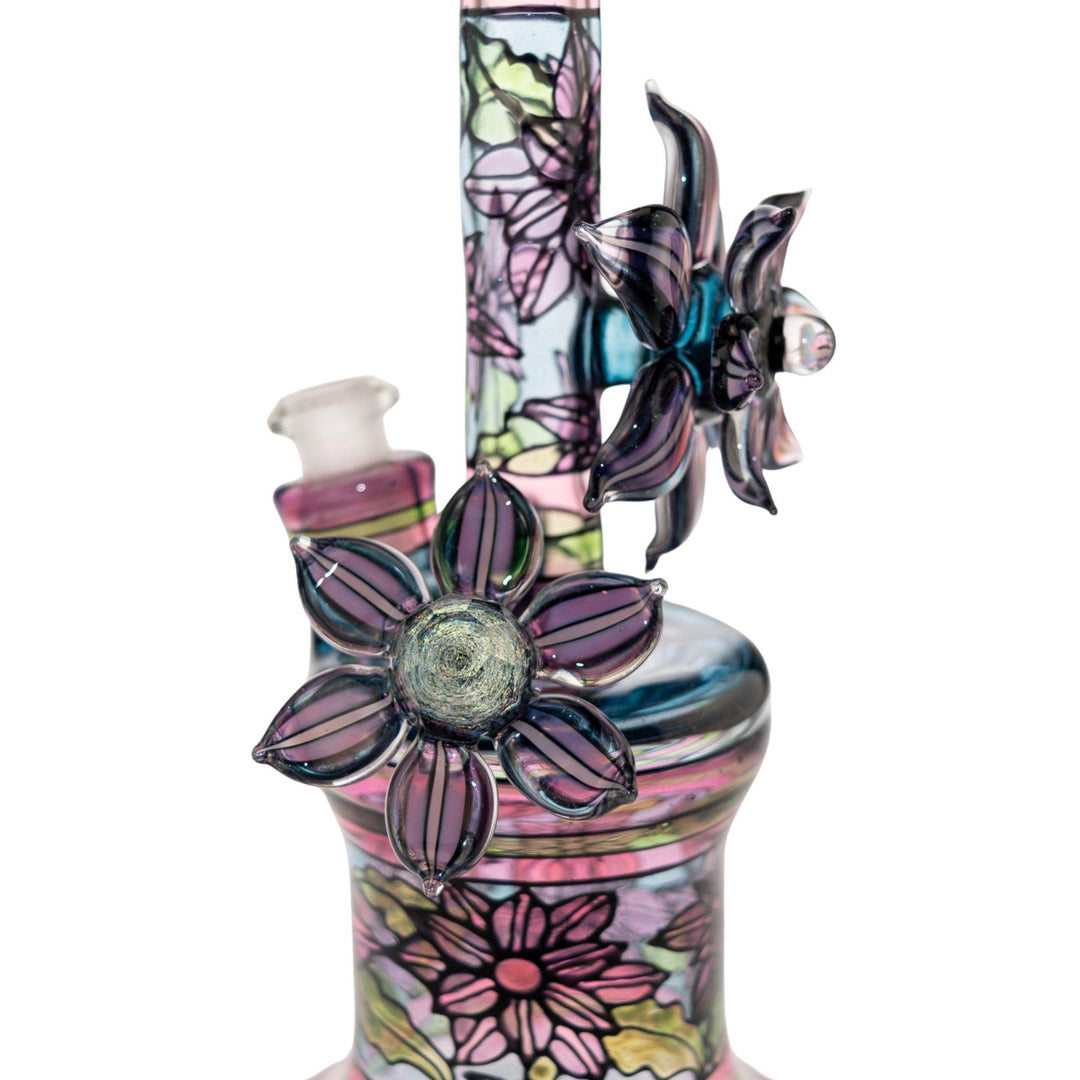 "Close-up of one of the dichroic flowers fastened to a Windstar x Mars Heady Collab on a white background," - Up N Smoke.