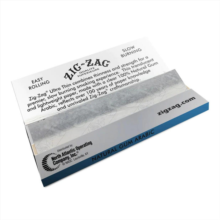 "Open booklet of Ultra Thin Zig Zag 1 1/4 Rolling Papers, revealing the dispensing area for the papers. Designed for a light and delicate smoking experience." - Up N Smoke.