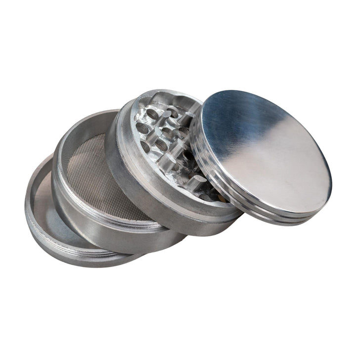 "A four-piece aluminum spice grinder with all its compartments laid out," - Up N Smoke.