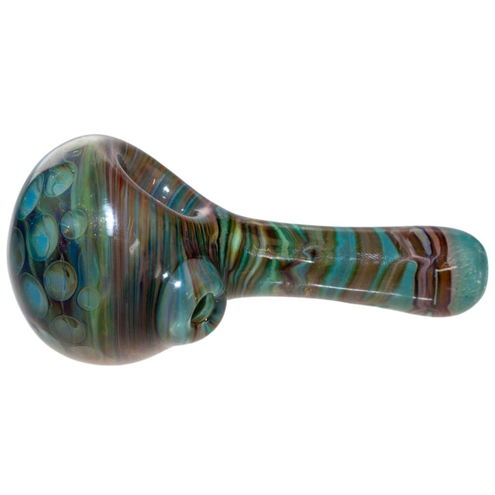 Left side view of a Fool Blown Marble Honeycomb spoon. This piece features blue, brown and green swirls and is adorned with glass bubbles. The front features a detailed and unique  honeycomb design. - Up N Smoke.