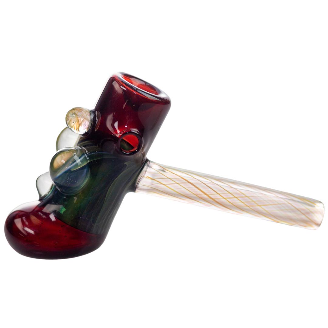 Left side view of a burgundy King Leo hammer bubbler with the carb showing. This piece features varying colors of glass marbles on the front of the hammer. - Up N Smoke.