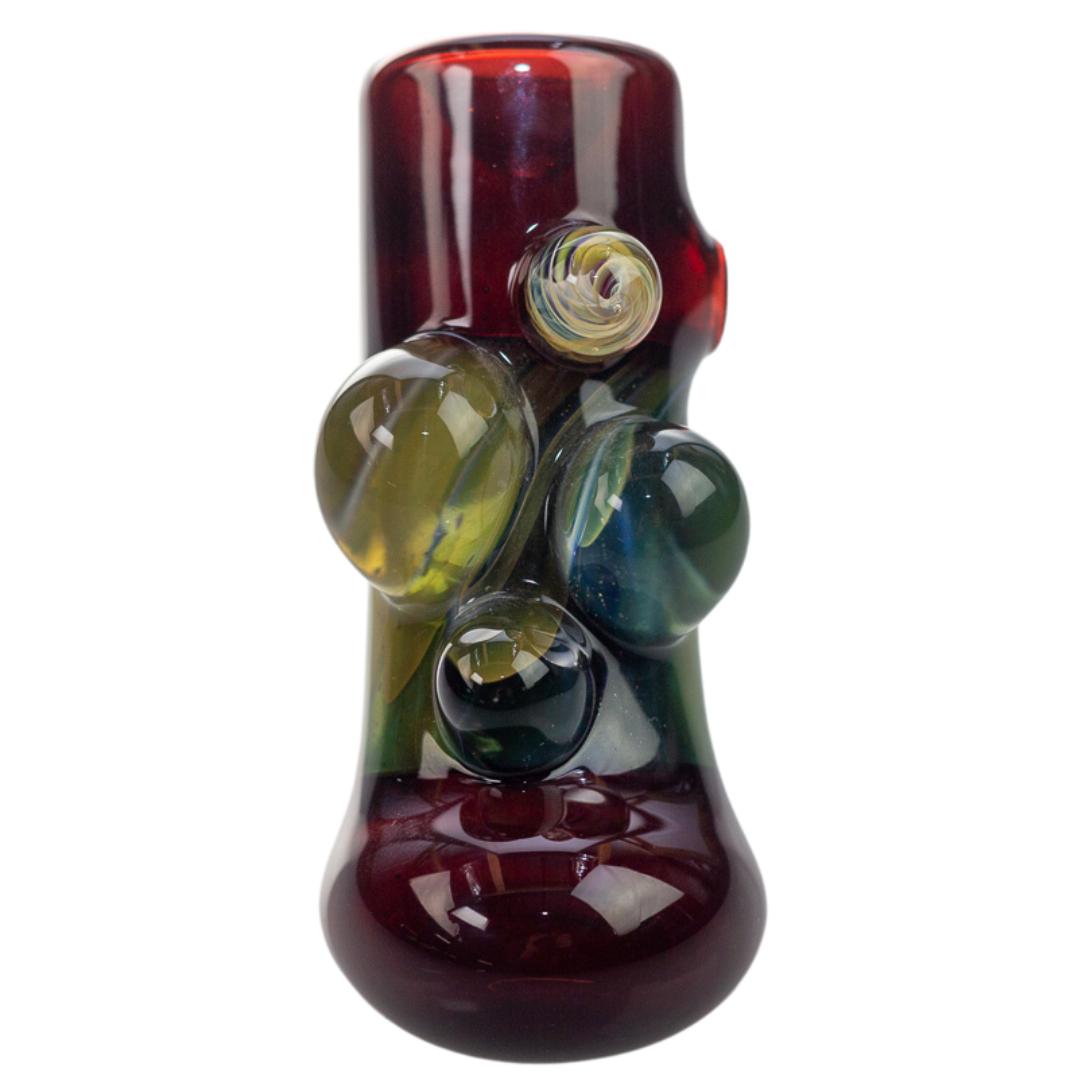 Front view of a burgundy hammer piece created by King Leo. This functional glass features four unique bubbles on the front. - Up N Smoke.