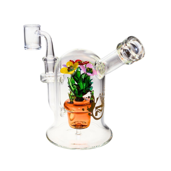 A studio photograph of the back of a Pulsar Summer Flowers dab rig. Inside the glass dome is a potted plant that doubles as the perc in the functional glass piece." - Up N Smoke.