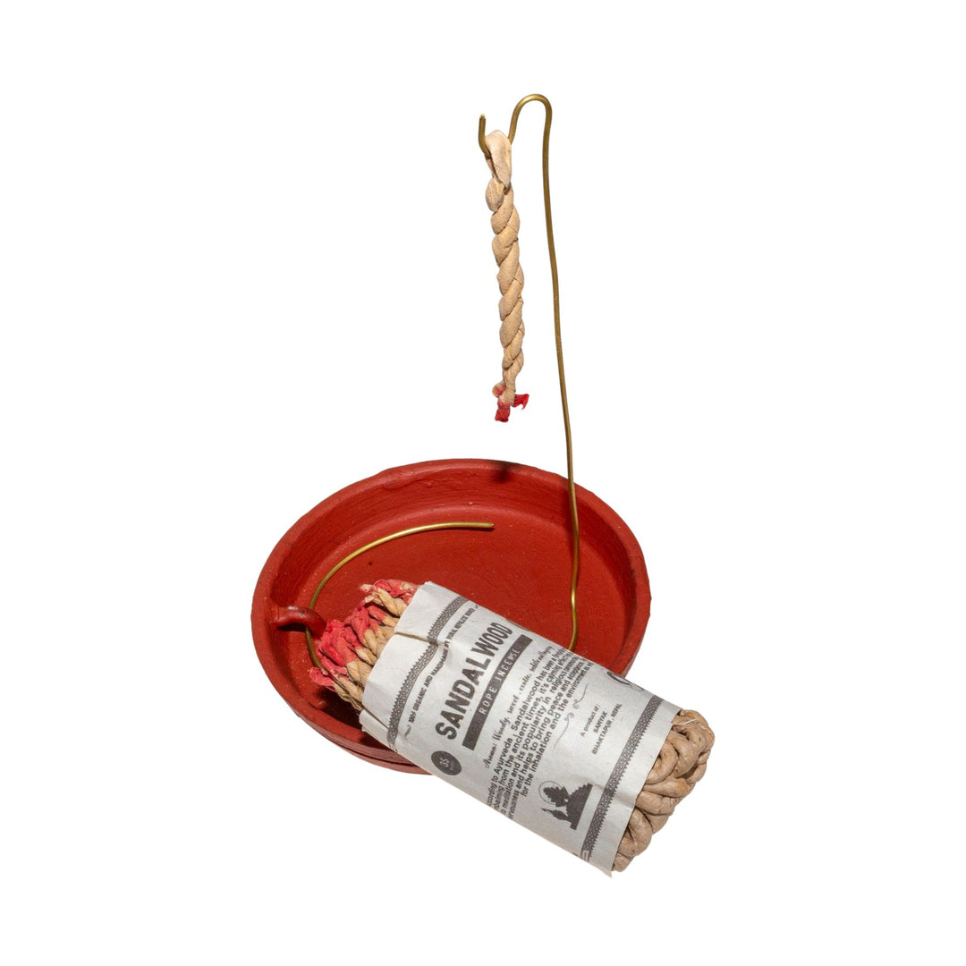 "A bundle of Sandalwood rope incense leans on a rope incense burner disc." - Up N Smoke.